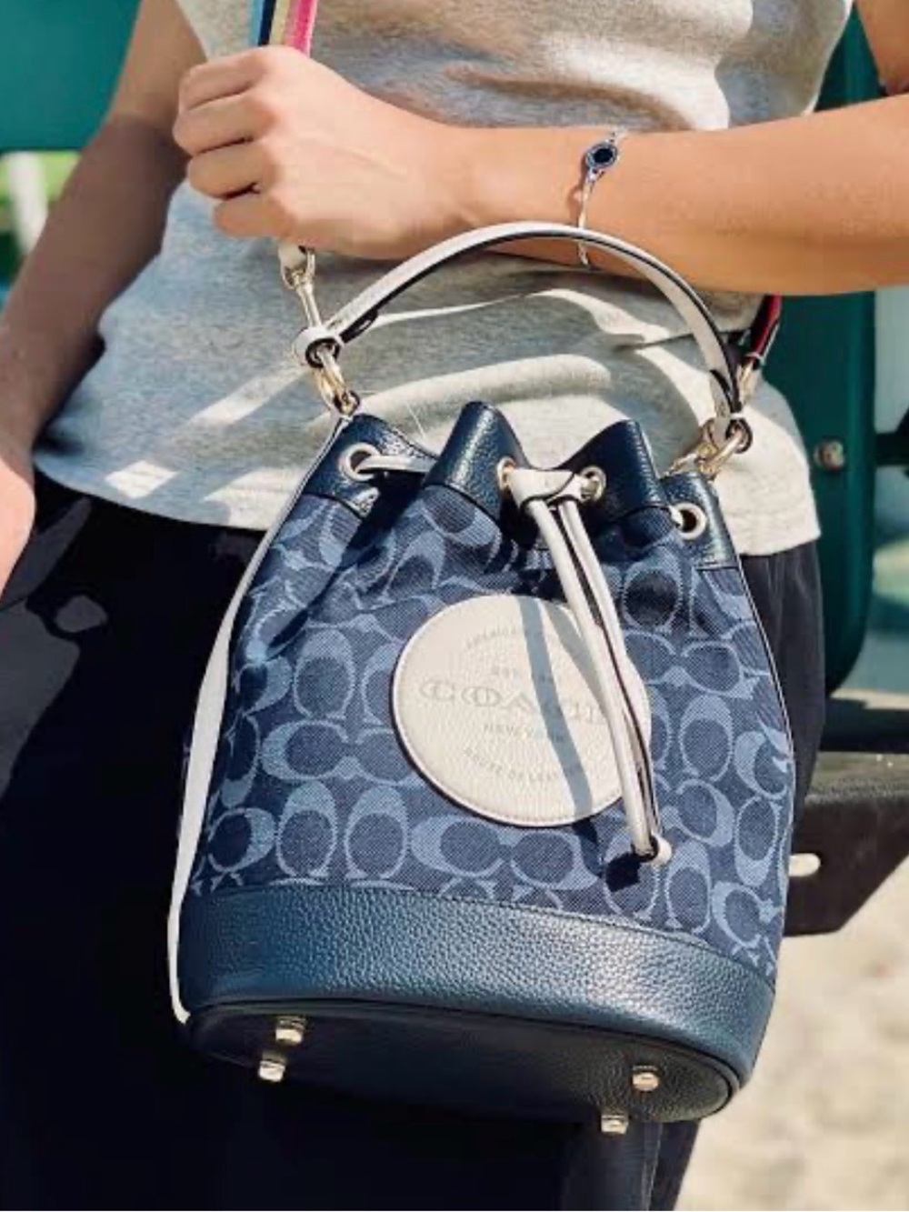 Coach Dempsey Drawstring Bucket Bag In Denim with Multicolor Rainbow Strap